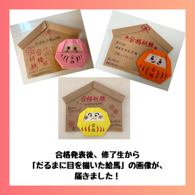 目の入ったダルマと絵馬